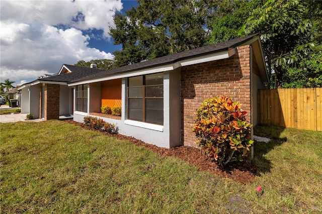 view of side of property with a lawn