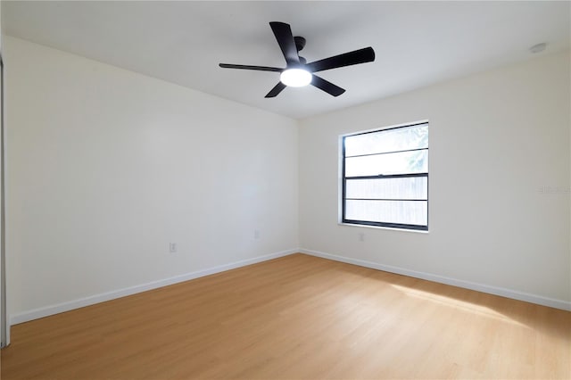 spare room with light wood-type flooring and ceiling fan