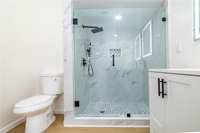 bathroom featuring hardwood / wood-style flooring, vanity, toilet, and an enclosed shower