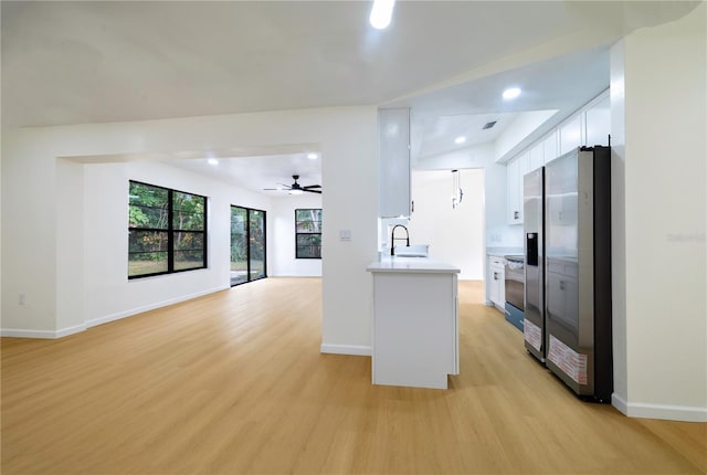 kitchen with white cabinetry, stainless steel refrigerator with ice dispenser, light hardwood / wood-style flooring, and sink