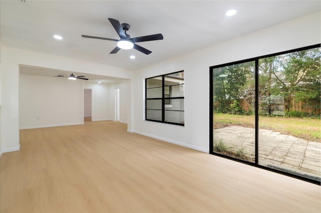 spare room with light hardwood / wood-style floors and ceiling fan