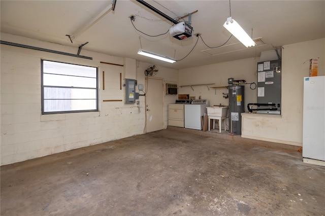 garage with heating unit, separate washer and dryer, sink, a garage door opener, and electric water heater