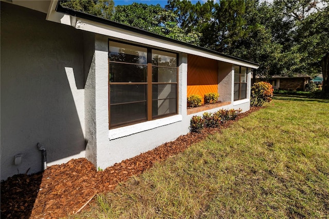 view of side of property with a lawn