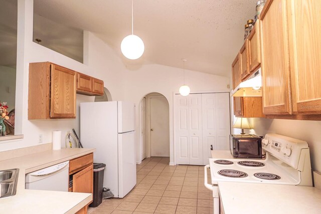 kitchen featuring hanging light fixtures, light tile patterned flooring, white appliances, and lofted ceiling