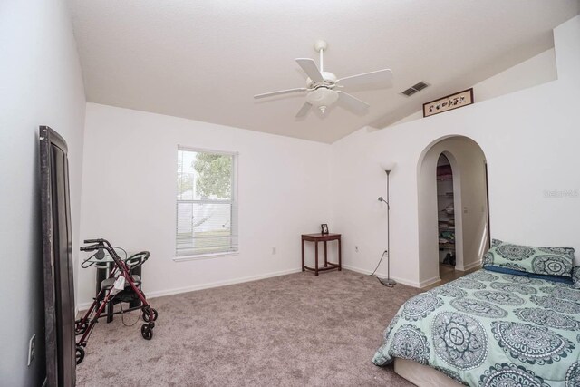 carpeted bedroom featuring lofted ceiling and ceiling fan