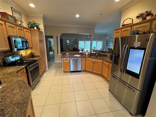 kitchen with ornamental molding, kitchen peninsula, appliances with stainless steel finishes, and sink