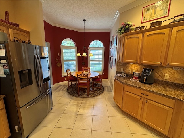 kitchen featuring light tile patterned flooring, crown molding, backsplash, decorative light fixtures, and stainless steel refrigerator with ice dispenser