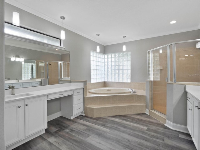 bathroom featuring ornamental molding, wood-type flooring, separate shower and tub, and vanity