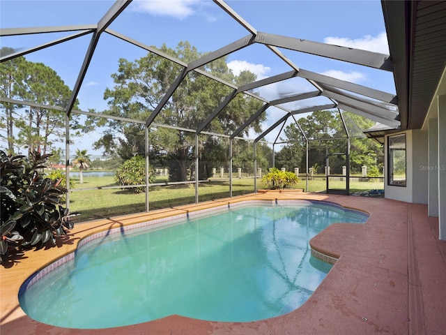 view of swimming pool with a patio, glass enclosure, and a lawn