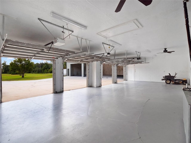 garage with a garage door opener and ceiling fan