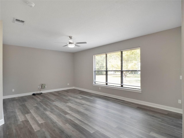 spare room featuring dark hardwood / wood-style flooring, a textured ceiling, and ceiling fan