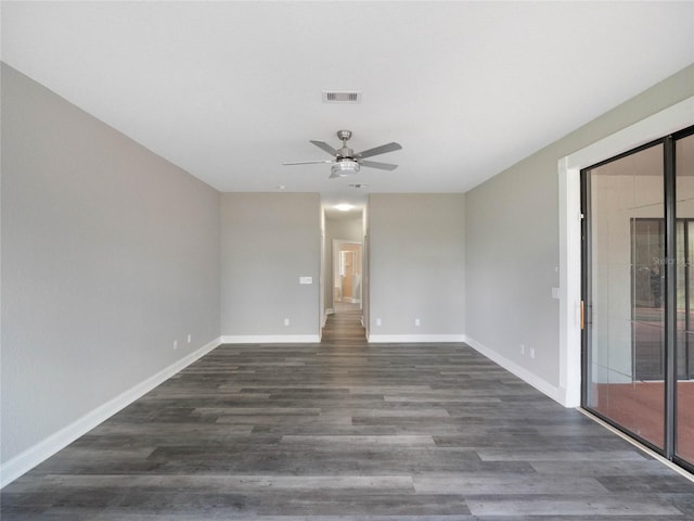 spare room featuring dark hardwood / wood-style flooring and ceiling fan