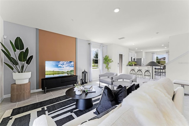 tiled living room featuring a wealth of natural light