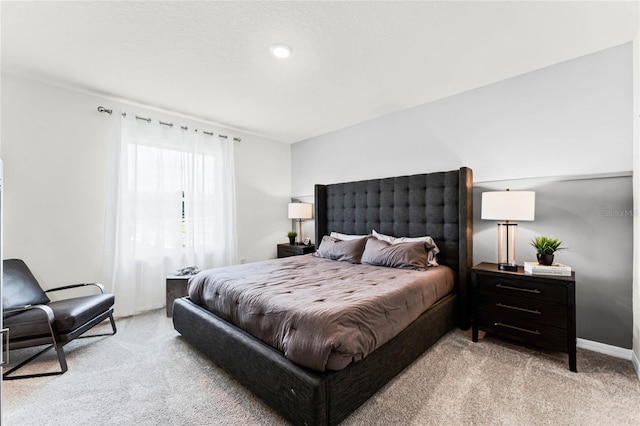 bedroom featuring light colored carpet