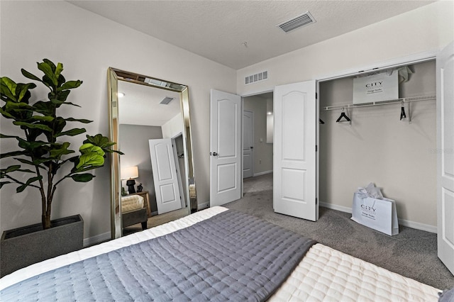 bedroom featuring a closet, a textured ceiling, and carpet flooring