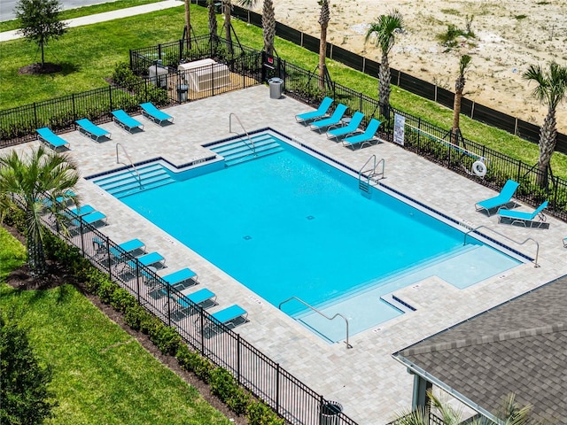 view of swimming pool featuring a patio area and a lawn