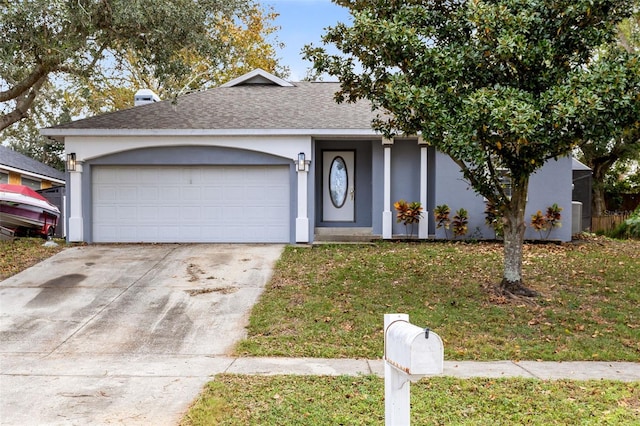 view of front of house with a garage and a front yard