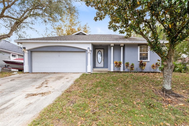 ranch-style house featuring a front lawn and a garage