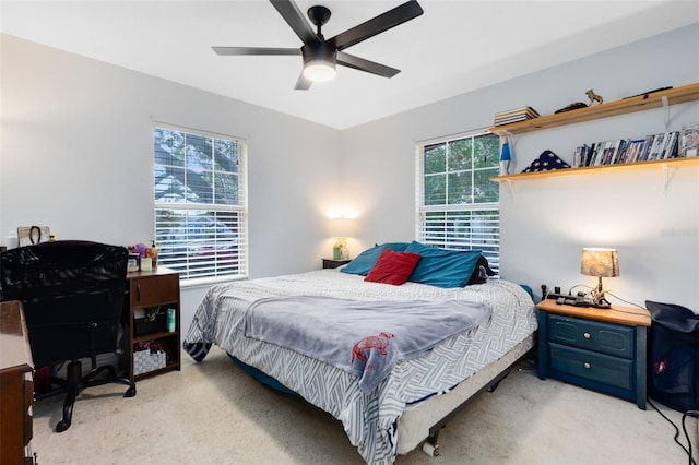 bedroom featuring light carpet and ceiling fan