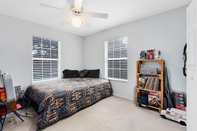 bedroom featuring light colored carpet and ceiling fan