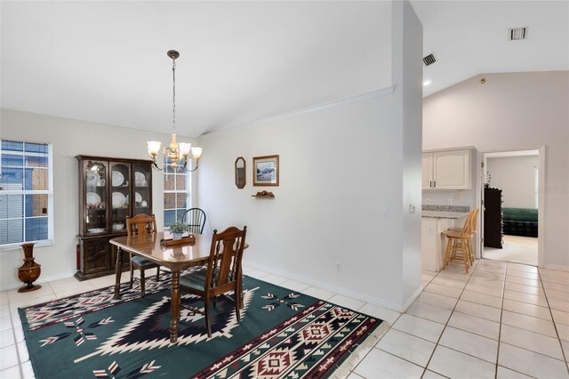 dining area featuring high vaulted ceiling, a notable chandelier, and light tile patterned flooring