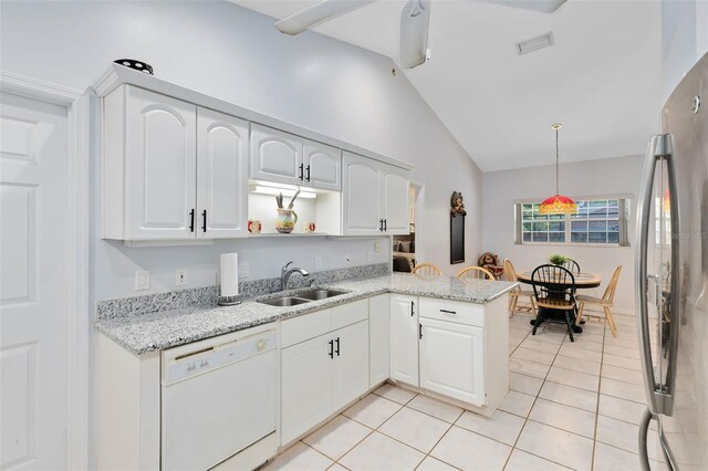 kitchen featuring white dishwasher, pendant lighting, sink, white cabinets, and kitchen peninsula