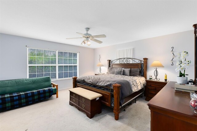 bedroom with ceiling fan and light carpet
