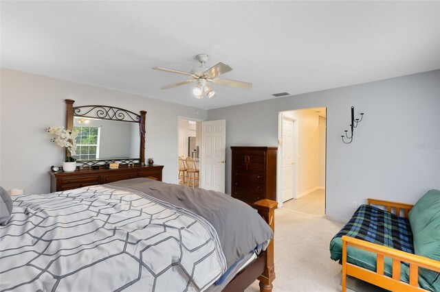 bedroom featuring light colored carpet and ceiling fan