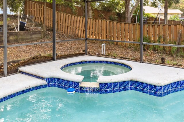 view of swimming pool with an in ground hot tub