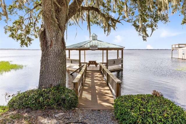 view of dock with a water view and a gazebo