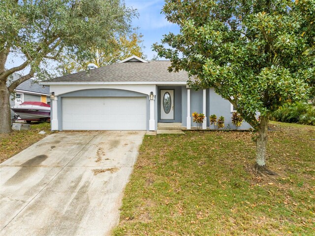single story home featuring a garage and a front yard