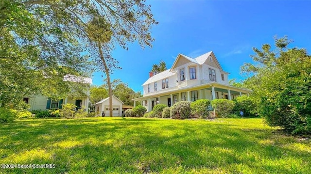 view of front of house featuring a front yard and covered porch