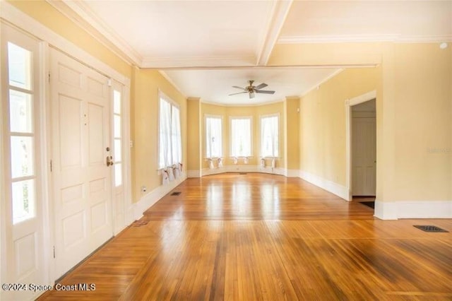 interior space with ornamental molding, beamed ceiling, wood-type flooring, and ceiling fan