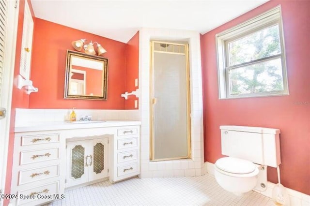 bathroom with vanity, tile patterned floors, toilet, and walk in shower