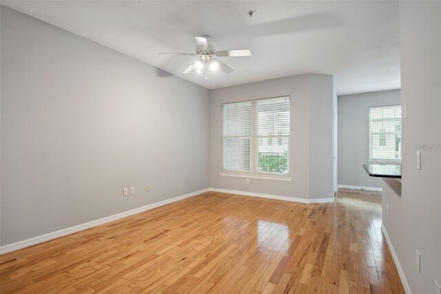 1810 E Palm Ave Unit 1205, Tampa, FL 33605 - unfurnished room featuring light wood-style flooring, baseboards, ceiling fan, and a pendent fire sprinkler