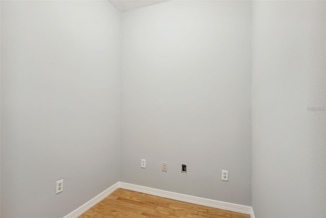 laundry area with hardwood / wood-style floors