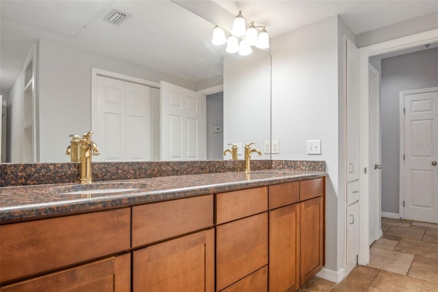 bathroom featuring vanity and an inviting chandelier