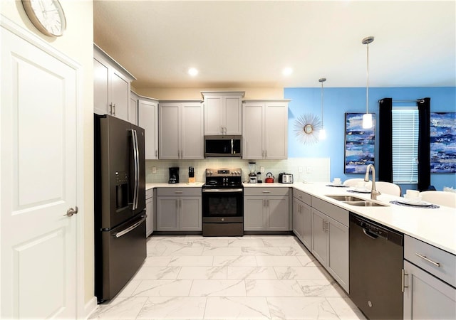 kitchen with backsplash, gray cabinets, decorative light fixtures, and appliances with stainless steel finishes