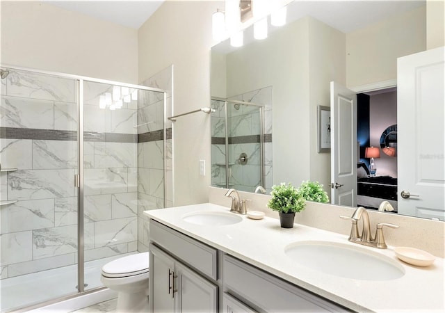 bathroom with vanity, toilet, and a shower with shower door