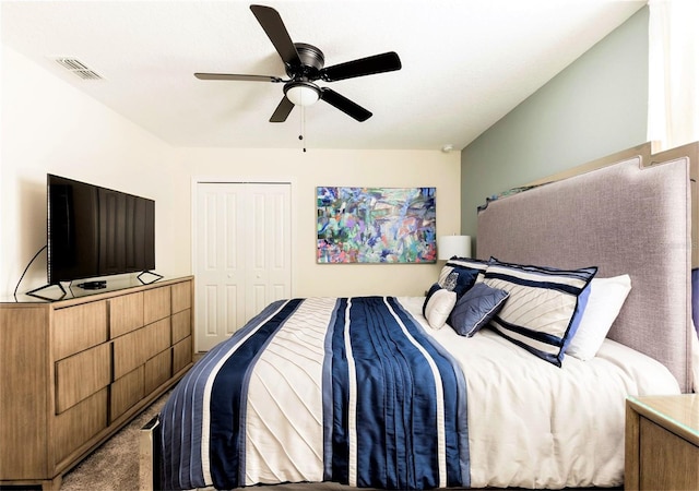 bedroom featuring carpet, ceiling fan, and a closet