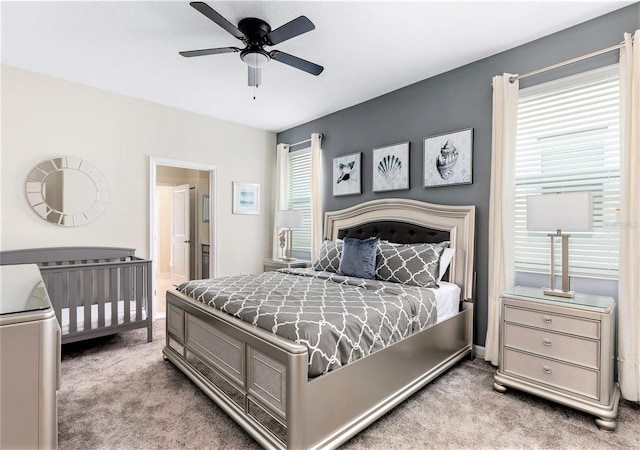 bedroom featuring ceiling fan and light carpet