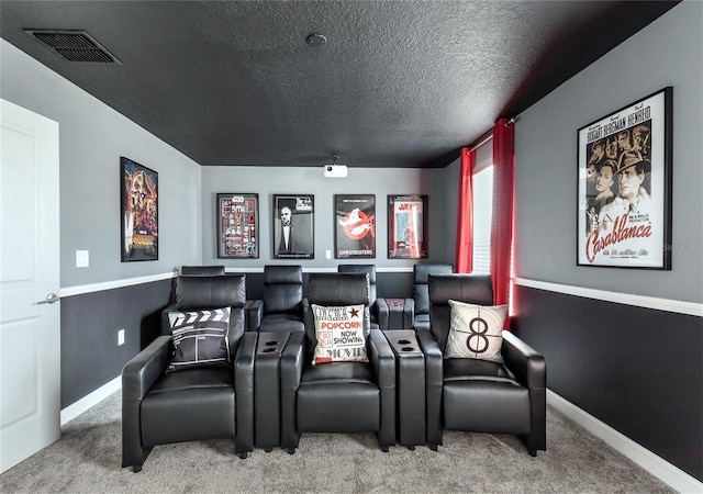 cinema featuring a textured ceiling and carpet