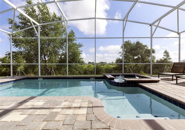 view of swimming pool featuring a patio, a lanai, and an in ground hot tub