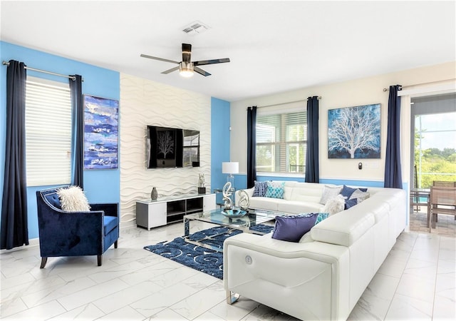 living room with a healthy amount of sunlight and ceiling fan