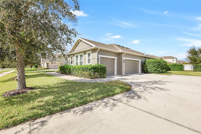 view of front of property featuring a front lawn and a garage