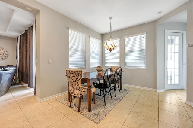 tiled dining room with plenty of natural light and a chandelier