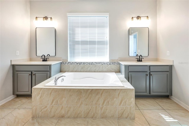 bathroom featuring a relaxing tiled tub, tile patterned flooring, and vanity