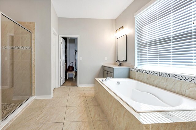 bathroom with tile patterned flooring, vanity, and separate shower and tub