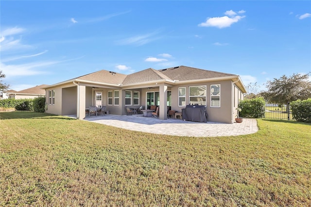 back of house with a yard and a patio