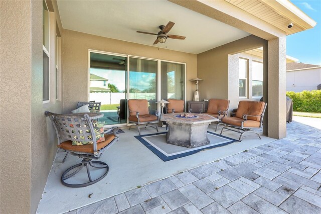 view of patio with a fire pit and ceiling fan